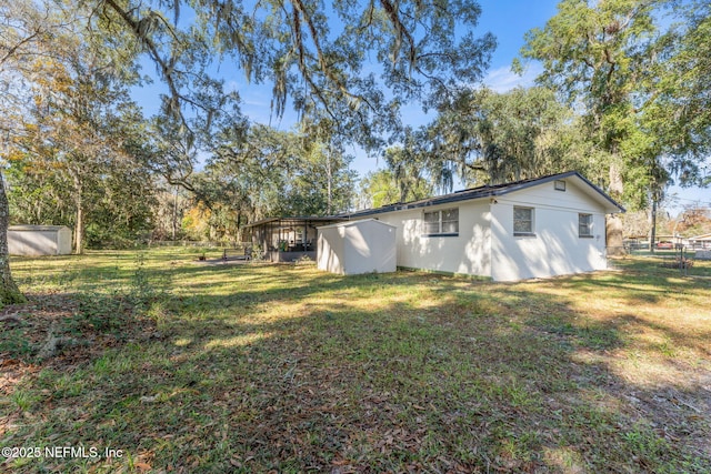 exterior space with a yard and a shed