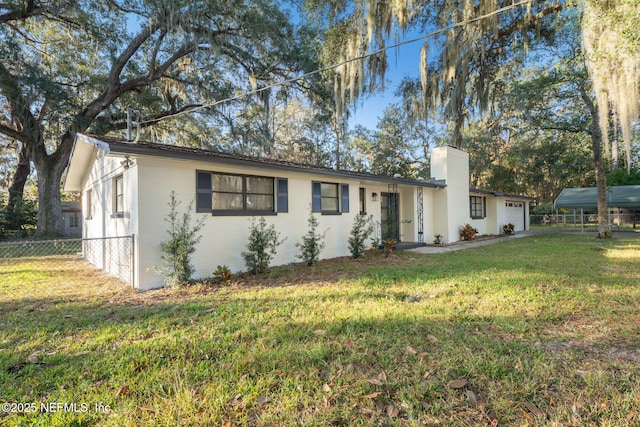 single story home featuring a front yard and a garage