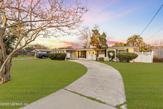 ranch-style house featuring a lawn