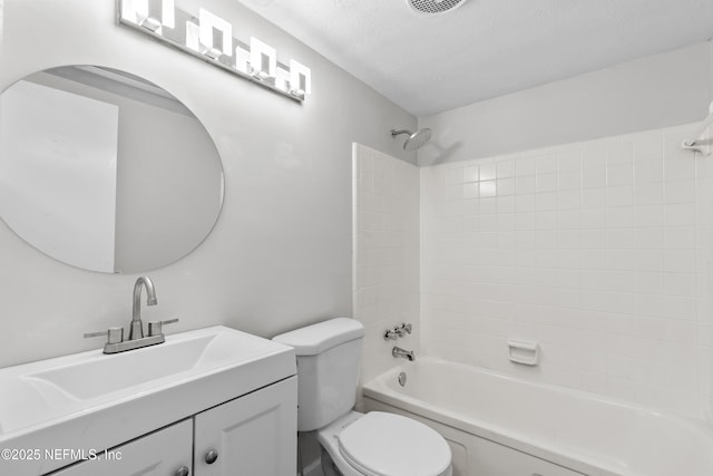 full bathroom with tiled shower / bath combo, vanity, a textured ceiling, and toilet