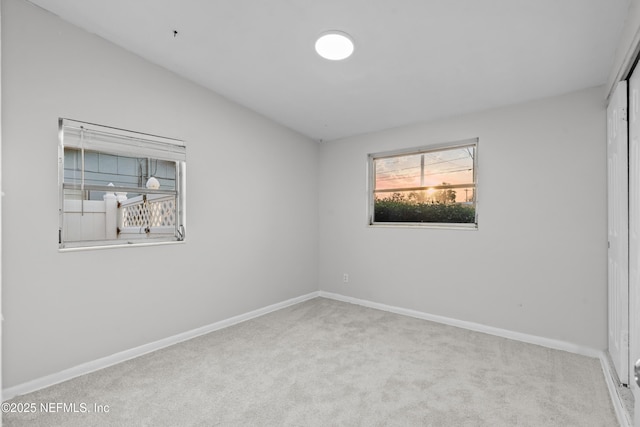 unfurnished room with light colored carpet