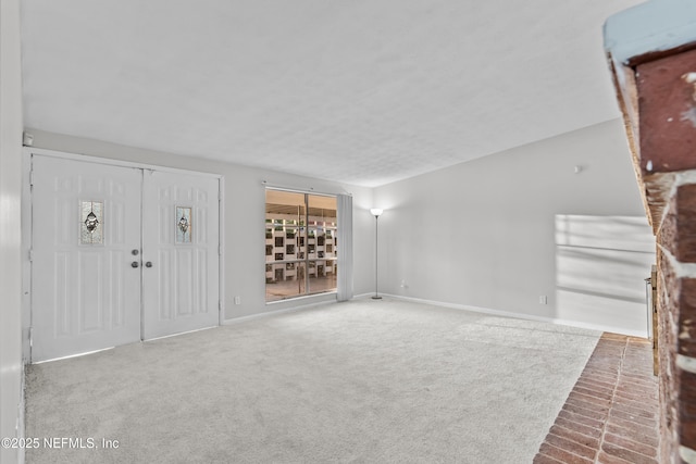 unfurnished living room featuring carpet