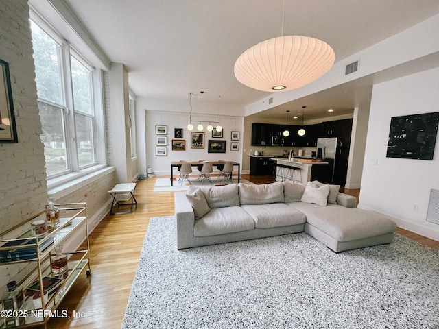 living room with wood-type flooring and plenty of natural light