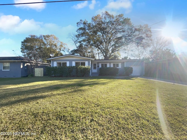 view of front facade featuring a front lawn and a garage