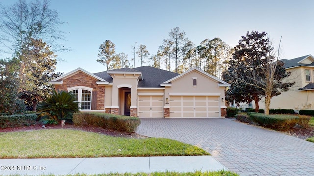 view of front of property with a front yard and a garage