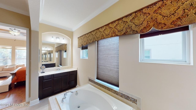 bathroom with plenty of natural light, ornamental molding, and vanity