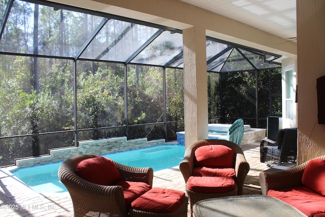 view of swimming pool with a jacuzzi, a patio, and a lanai