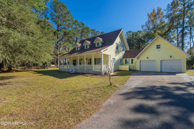 cape cod home featuring a garage, a front yard, and covered porch