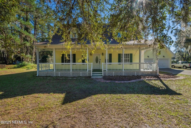 view of front of house featuring a porch, a garage, and a front yard