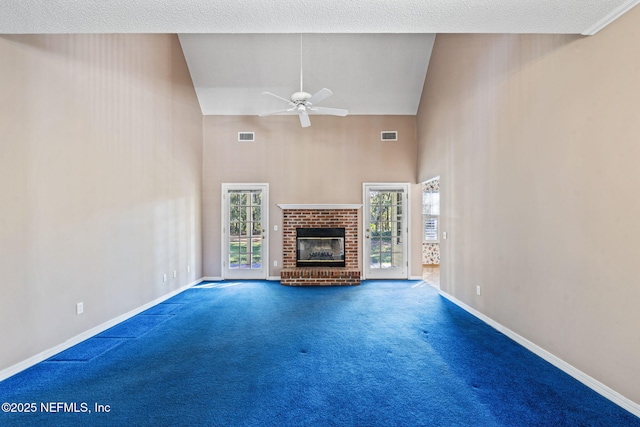 unfurnished living room featuring ceiling fan, high vaulted ceiling, carpet floors, and a fireplace