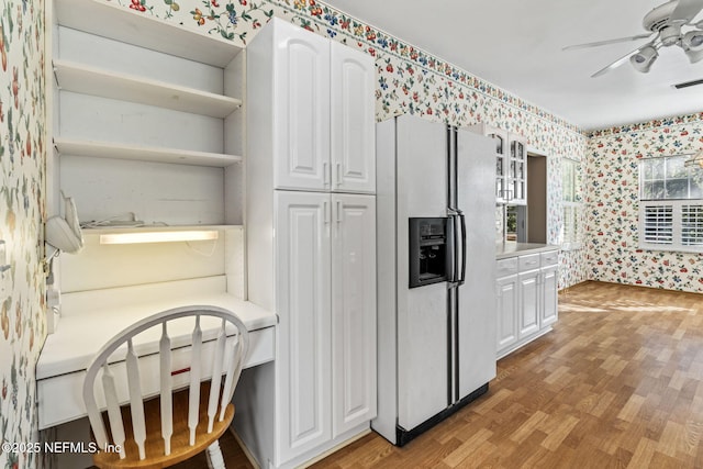 kitchen with hardwood / wood-style flooring, white fridge with ice dispenser, white cabinets, and ceiling fan