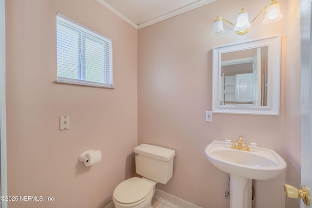 bathroom featuring crown molding and toilet