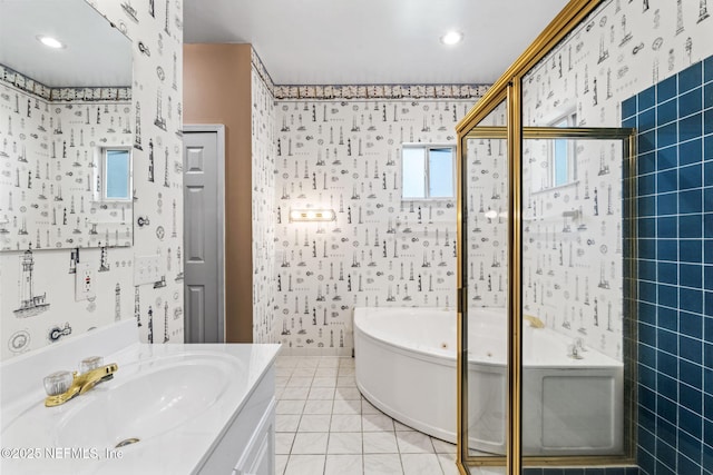 bathroom with tile patterned flooring, vanity, independent shower and bath, and tile walls