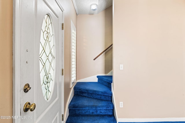 entrance foyer featuring a textured ceiling