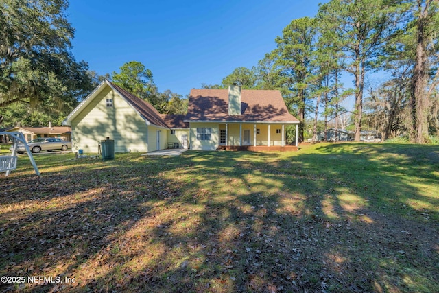 view of front of home featuring a front yard and covered porch