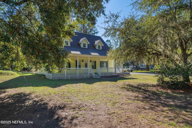 view of front of home with covered porch and a front yard