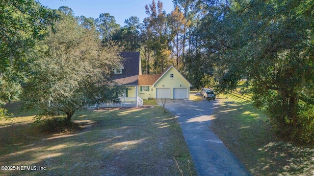 view of front of property featuring a garage and a front yard