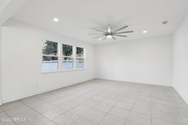 tiled empty room featuring ceiling fan