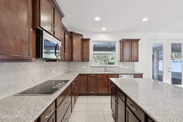 kitchen with backsplash, french doors, sink, light tile patterned floors, and appliances with stainless steel finishes