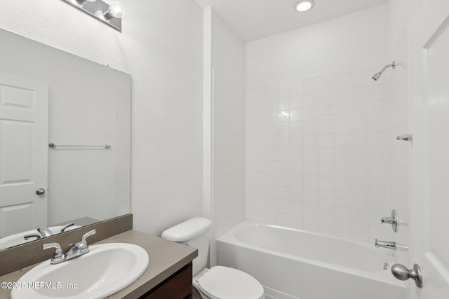 full bathroom with vanity,  shower combination, toilet, and a textured ceiling