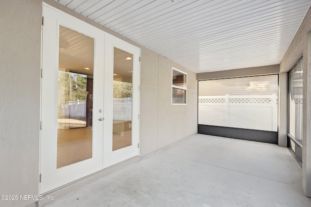 unfurnished sunroom with french doors