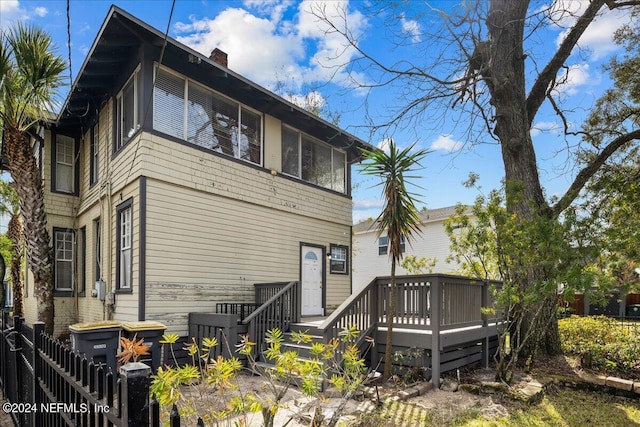 rear view of house with a wooden deck