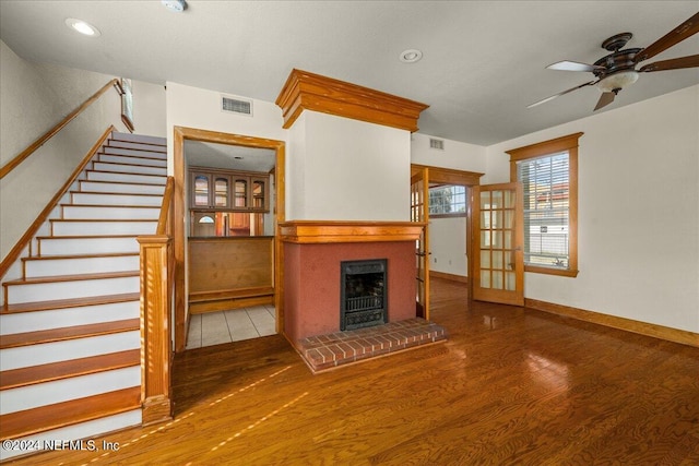 unfurnished living room featuring ceiling fan and hardwood / wood-style floors