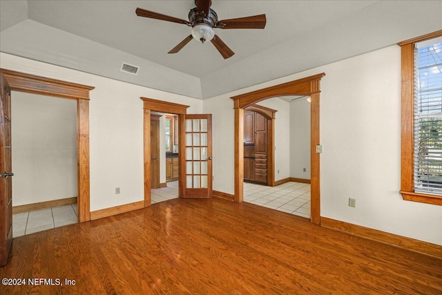 unfurnished room featuring french doors, ceiling fan, and light hardwood / wood-style flooring