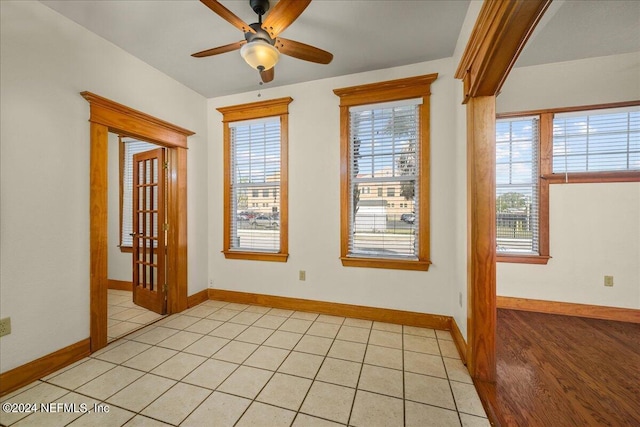 tiled empty room with ceiling fan