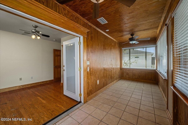 unfurnished sunroom featuring ceiling fan and wood ceiling