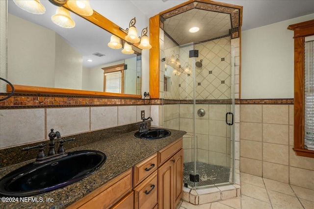 bathroom with tile walls, vanity, and an enclosed shower