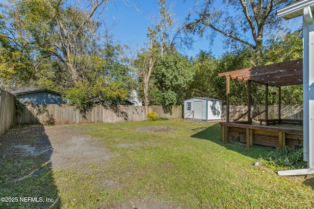 view of yard featuring a pergola and a storage unit