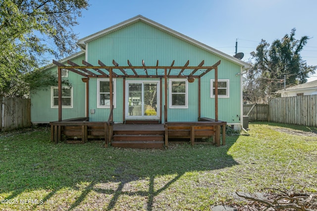 back of property featuring a pergola and a yard