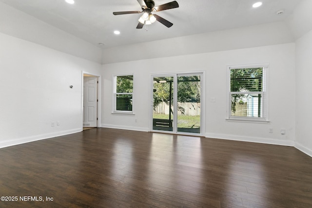 empty room featuring ceiling fan, dark hardwood / wood-style floors, and lofted ceiling