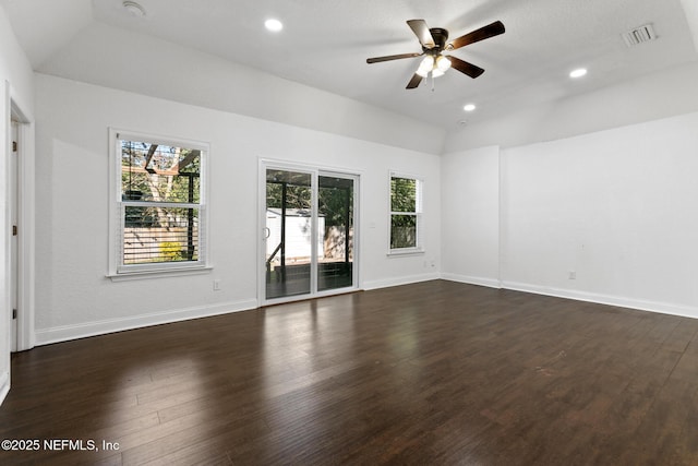 empty room with ceiling fan, lofted ceiling, and dark hardwood / wood-style floors