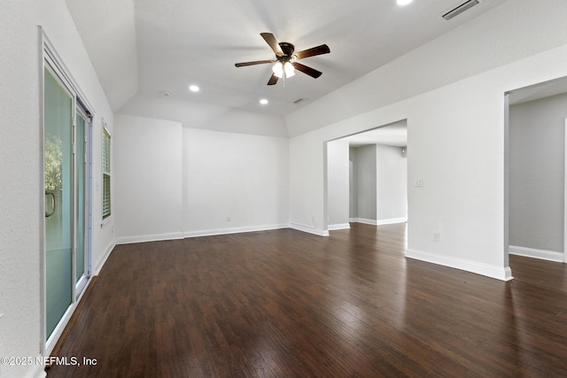 unfurnished room with ceiling fan, dark wood-type flooring, and lofted ceiling