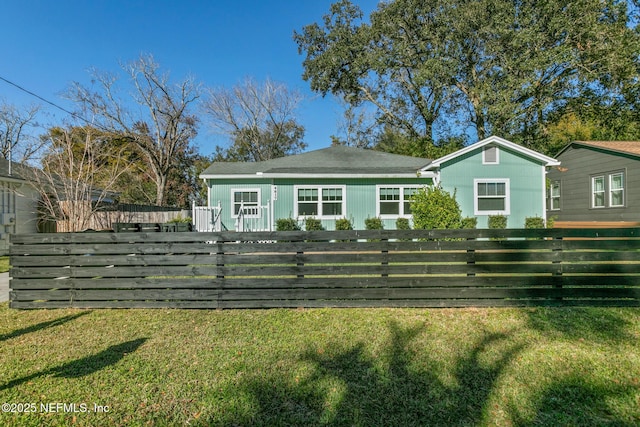 rear view of property with a lawn