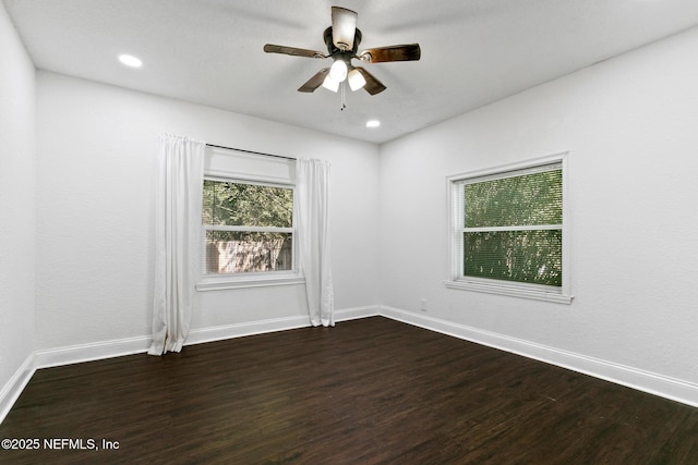 spare room featuring ceiling fan and dark hardwood / wood-style floors