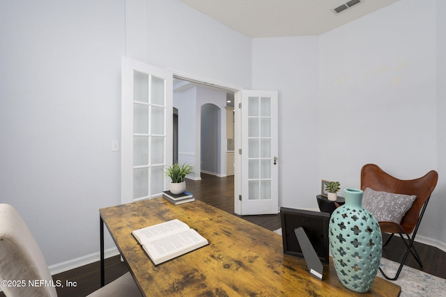 office with dark hardwood / wood-style flooring and french doors