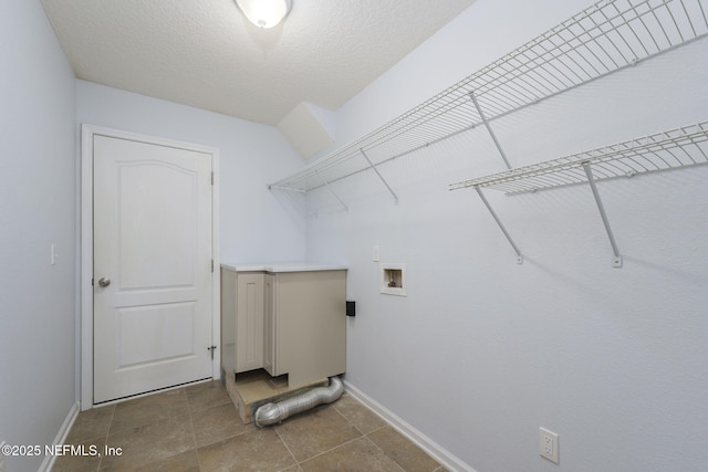 laundry room featuring hookup for a washing machine and a textured ceiling