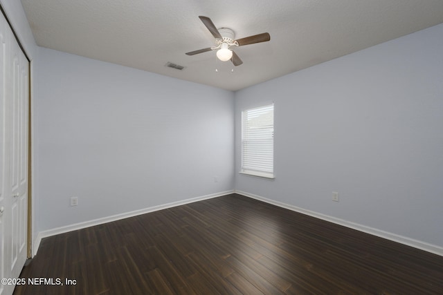 interior space featuring a textured ceiling, dark wood-type flooring, a closet, and ceiling fan