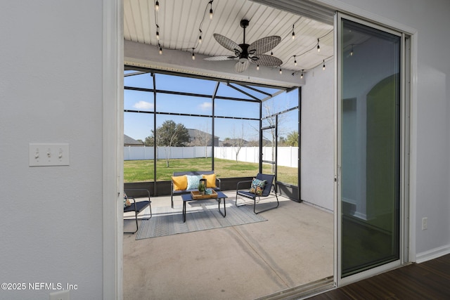 view of patio / terrace with ceiling fan and glass enclosure