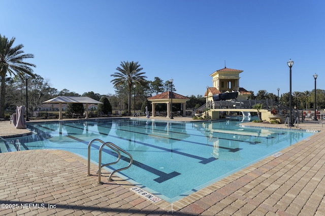 view of pool with a gazebo and a water slide