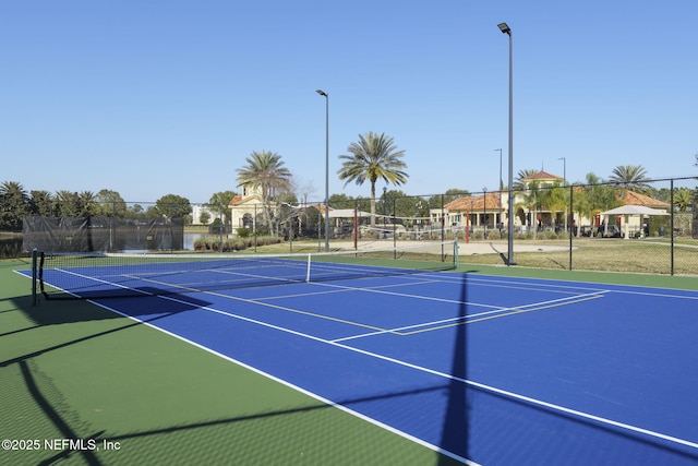 view of tennis court with basketball hoop