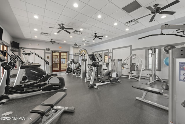 gym with a drop ceiling and french doors