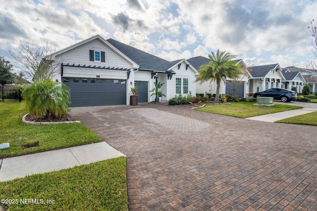 ranch-style home with a garage and a front yard