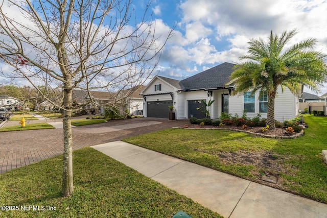 view of front of property with a front lawn and a garage