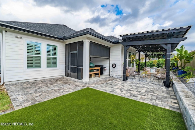 rear view of property with roof with shingles, a yard, a patio, a sunroom, and a pergola