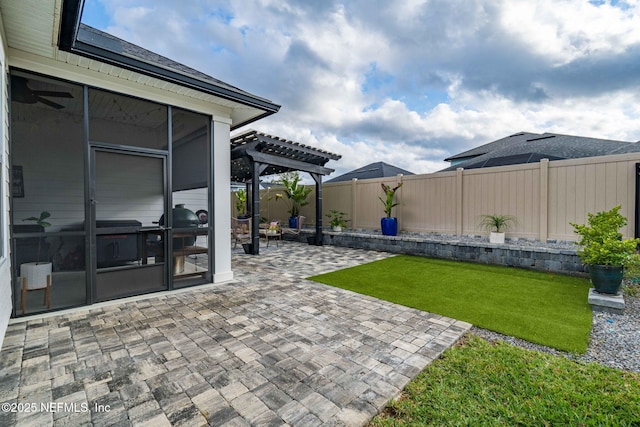 view of patio / terrace featuring fence private yard, a sunroom, and a pergola