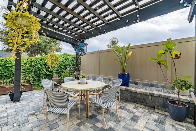 view of patio / terrace featuring outdoor dining space, fence, and a pergola